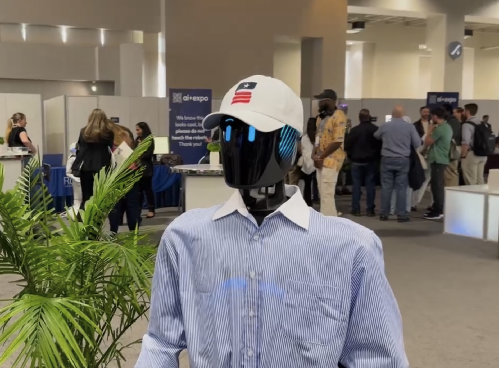 Ada, an IntBot humanoid, greeting attendees at AI+ Expo